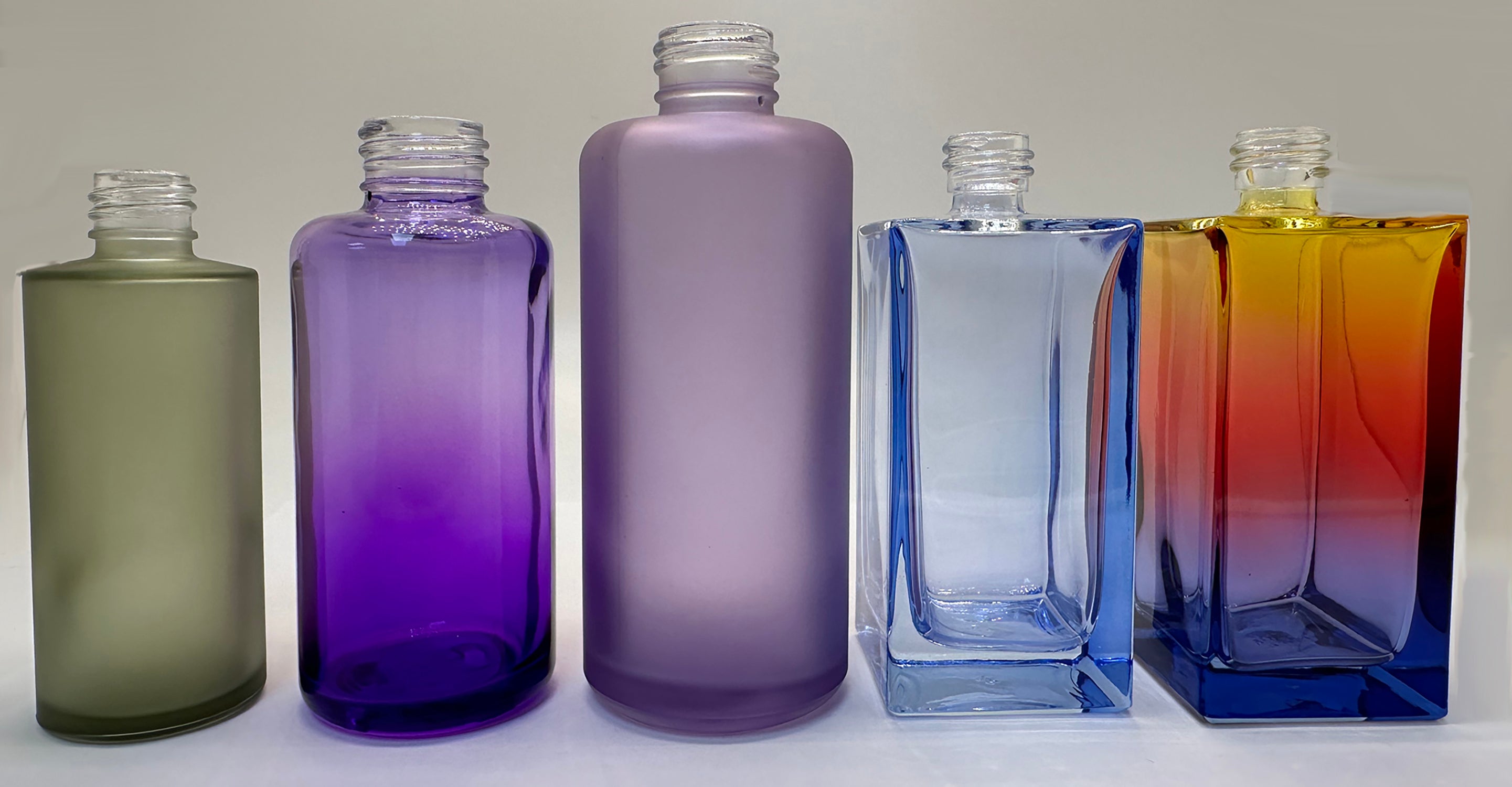 Glass bottles and jars in colorful custom finishes